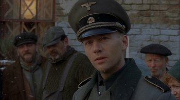Movie still from “Dominion: Prequel to the Exorcist” (2005), directed by Paul Schrader – A man in a military uniform stands in front of another man; Close Up shot, Over the shoulder angle