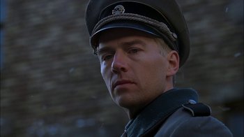 Movie still from “Dominion: Prequel to the Exorcist” (2005), directed by Paul Schrader – A person wearing a hat; Close Up shot, Low angle