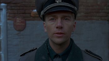 Movie still from “Dominion: Prequel to the Exorcist” (2005), directed by Paul Schrader – A person wearing a uniform; Close Up shot, Low angle