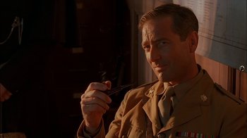 Movie still from “Dominion: Prequel to the Exorcist” (2005), directed by Paul Schrader – A man holding a cigarette in his mouth; Close Up shot, Low angle
