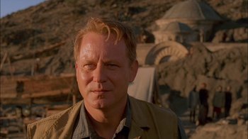 Movie still from “Dominion: Prequel to the Exorcist” (2005), directed by Paul Schrader – A person wearing a vest; Close Up shot, Over the shoulder angle