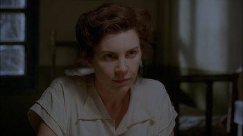 Movie still from “Dominion: Prequel to the Exorcist” (2005), directed by Paul Schrader – A person sitting in a room; Close Up shot, Over the shoulder angle