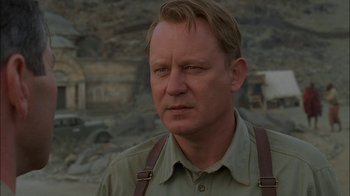 Movie still from “Dominion: Prequel to the Exorcist” (2005), directed by Paul Schrader – A person wearing a shirt and suspenders; Close Up shot, Low angle