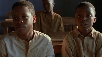 Movie still from “Dominion: Prequel to the Exorcist” (2005), directed by Paul Schrader – A group of young men sitting next to each other in a room; Close Up shot, Low angle