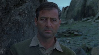 Movie still from “Dominion: Prequel to the Exorcist” (2005), directed by Paul Schrader – A person wearing a sweater; Close Up shot, Low angle