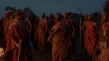 Movie still from “Dominion: Prequel to the Exorcist” (2005), directed by Paul Schrader – A group of men in traditional clothing and headgear; Wide shot, Over the shoulder angle