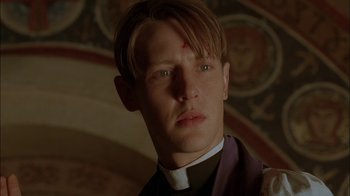 Movie still from “Dominion: Prequel to the Exorcist” (2005), directed by Paul Schrader – A man with a cross on his forehead; Close Up shot, Low angle