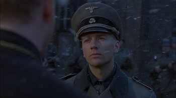 Movie still from “Dominion: Prequel to the Exorcist” (2005), directed by Paul Schrader – A man in a military uniform is looking at the camera; Close Up shot, Over the shoulder angle