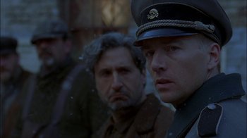 Movie still from “Dominion: Prequel to the Exorcist” (2005), directed by Paul Schrader – A man in a military uniform looking out of a window; Close Up shot, Over the shoulder angle