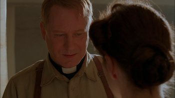 Movie still from “Dominion: Prequel to the Exorcist” (2005), directed by Paul Schrader – A man and a woman are looking at each other; Close Up shot, Over the shoulder angle
