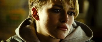 Movie still from “Domino” (2005), directed by Tony Scott – A person's face in a dimly - lit room; Close Up shot, Low angle