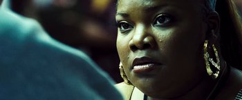 Movie still from “Domino” (2005), directed by Tony Scott – A woman's face in a dark room; Close Up shot, Over the shoulder angle
