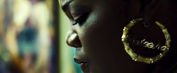 Movie still from “Domino” (2005), directed by Tony Scott – A woman's face with a piercing in her ear; Extreme Close Up shot, Low angle