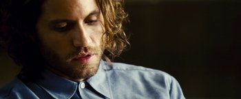 Movie still from “Domino” (2005), directed by Tony Scott – A person with long hair; Close Up shot, Over the shoulder angle