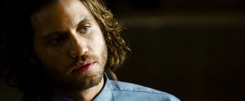 Movie still from “Domino” (2005), directed by Tony Scott – A person wearing a blue shirt; Close Up shot, Over the shoulder angle