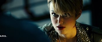Movie still from “Domino” (2005), directed by Tony Scott – A person wearing a jacket; Close Up shot, Over the shoulder angle