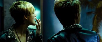 Movie still from “Domino” (2005), directed by Tony Scott – A woman in a leather jacket looking at another woman in a leather jacket; Close Up shot, Over the shoulder angle
