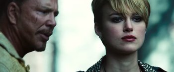 Movie still from “Domino” (2005), directed by Tony Scott – A person wearing a necklace; Close Up shot, Over the shoulder angle