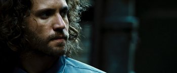 Movie still from “Domino” (2005), directed by Tony Scott – A person with long hair; Close Up shot, Over the shoulder angle