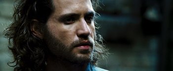 Movie still from “Domino” (2005), directed by Tony Scott – A person with long hair; Close Up shot, Over the shoulder angle