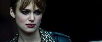 Movie still from “Domino” (2005), directed by Tony Scott – A person wearing a leather jacket; Close Up shot, Over the shoulder angle