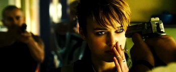 Movie still from “Domino” (2005), directed by Tony Scott – A person smoking a cigarette; Close Up shot, Over the shoulder angle