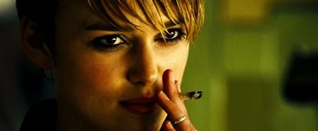 Movie still from “Domino” (2005), directed by Tony Scott – A person holding a cigarette in her mouth; Close Up shot, Low angle