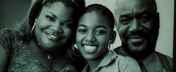 Movie still from “Domino” (2005), directed by Tony Scott – A group of people that are posing for a picture; Close Up shot, High angle