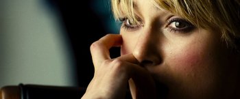 Movie still from “Domino” (2005), directed by Tony Scott – A person with her hand to her face; Extreme Close Up shot, High angle