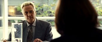 Movie still from “Domino” (2005), directed by Tony Scott – A man sitting at a table talking to a woman; Close Up shot, Over the shoulder angle