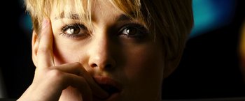 Movie still from “Domino” (2005), directed by Tony Scott – A woman's face with her hand on her chin; Extreme Close Up shot, Low angle