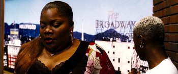 Movie still from “Domino” (2005), directed by Tony Scott – A person wearing a dress; Close Up shot, Low angle