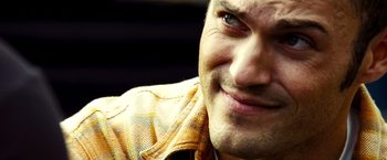 Movie still from “Domino” (2005), directed by Tony Scott – A person wearing a yellow shirt; Close Up shot, Over the shoulder angle