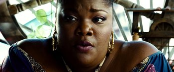 Movie still from “Domino” (2005), directed by Tony Scott – A person wearing gold jewelry; Close Up shot, High angle