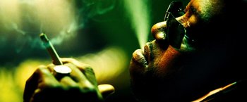 Movie still from “Domino” (2005), directed by Tony Scott – View of a person's hand with gold fingernail polish; Extreme Close Up shot, Low angle