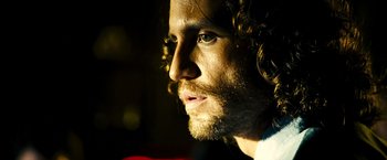Movie still from “Domino” (2005), directed by Tony Scott – A person with a beard; Close Up shot, Low angle