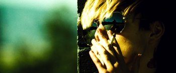 Movie still from “Domino” (2005), directed by Tony Scott – A person with a cigarette in their hand; Extreme Close Up shot, Low angle