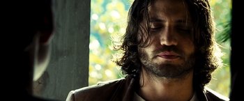 Movie still from “Domino” (2005), directed by Tony Scott – A person with long hair; Close Up shot, Low angle