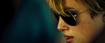 Movie still from “Domino” (2005), directed by Tony Scott – A person wearing sunglasses; Close Up shot, Over the shoulder angle