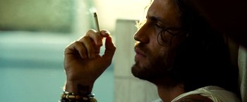 Movie still from “Domino” (2005), directed by Tony Scott – A person smoking a cigarette; Close Up shot, Low angle
