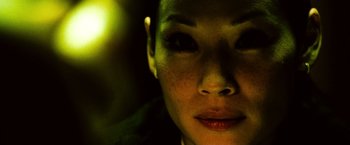 Movie still from “Domino” (2005), directed by Tony Scott – A woman's face in the dark; Close Up shot, High angle