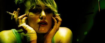 Movie still from “Domino” (2005), directed by Tony Scott – A woman with green hair is talking on the phone; Close Up shot, Overhead angle