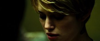 Movie still from “Domino” (2005), directed by Tony Scott – A woman's face with blonde hair; Close Up shot, Over the shoulder angle
