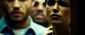 Movie still from “Domino” (2005), directed by Tony Scott – A woman's face in front of a man's face; Close Up shot, Over the shoulder angle