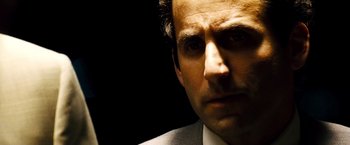Movie still from “Domino” (2005), directed by Tony Scott – A person wearing a suit and tie; Close Up shot, Over the shoulder angle