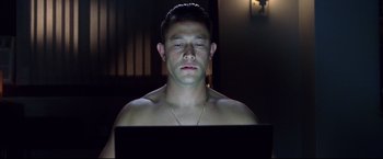 Movie still from “Don Jon” (2013), directed by Joseph Gordon-Levitt – A man with his eyes closed using a laptop; Close Up shot, High angle