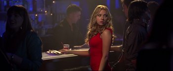 Movie still from “Don Jon” (2013), directed by Joseph Gordon-Levitt – A woman in a red dress standing in front of a bar; Medium shot, Over the shoulder angle