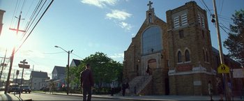 Movie still from “Don Jon” (2013), directed by Joseph Gordon-Levitt – A man walking down the sidewalk in front of a church; Extreme Wide shot, Low angle