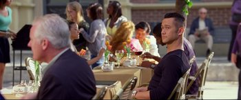 Movie still from “Don Jon” (2013), directed by Joseph Gordon-Levitt – A group of people sitting at a table with food; Medium shot, Over the shoulder angle