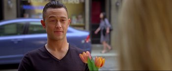 Movie still from “Don Jon” (2013), directed by Joseph Gordon-Levitt – A person holding a bouquet of flowers; Close Up shot, Over the shoulder angle